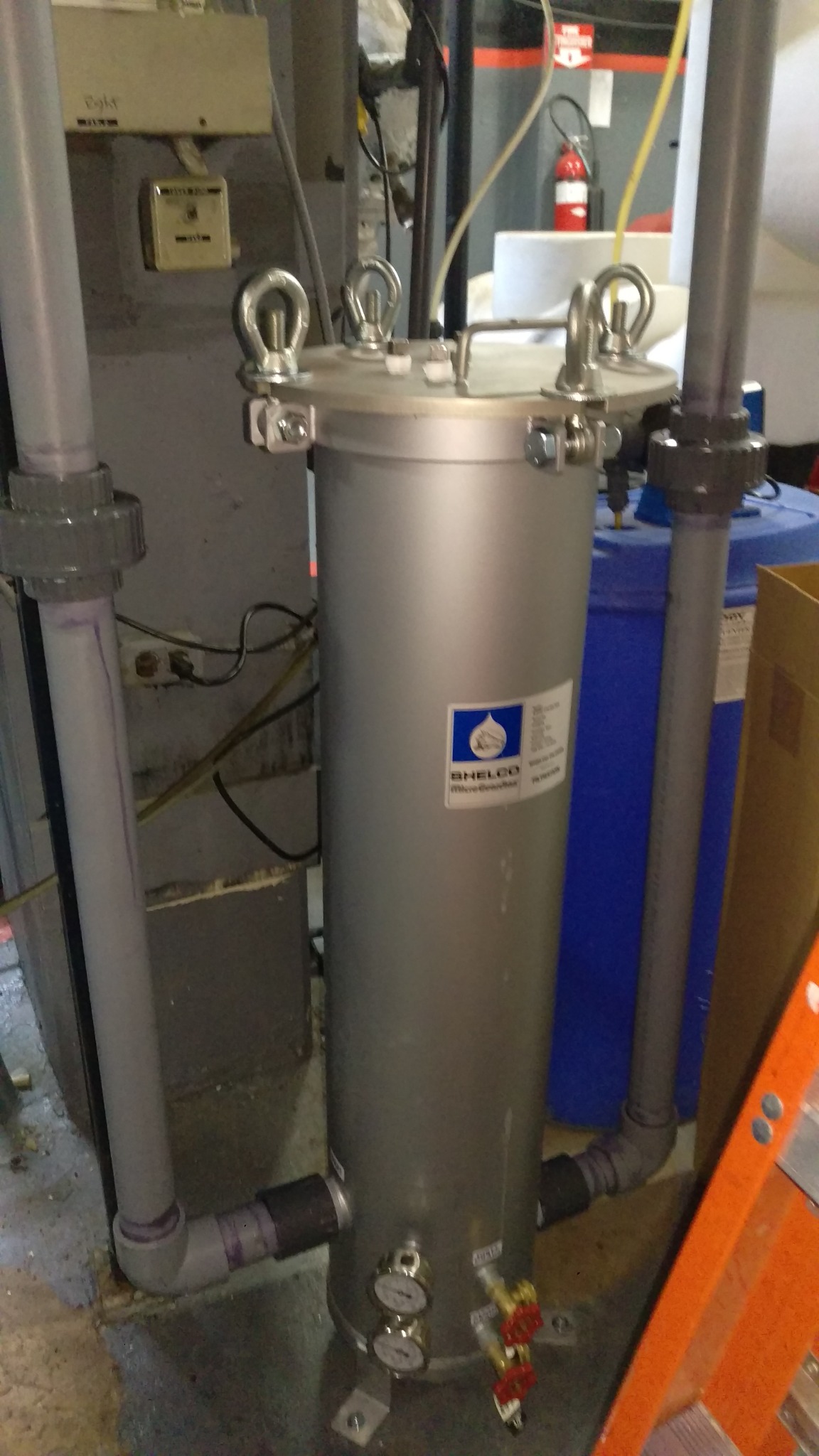 Cooling tower filtration assembly with stainless steel filter housing and connected piping